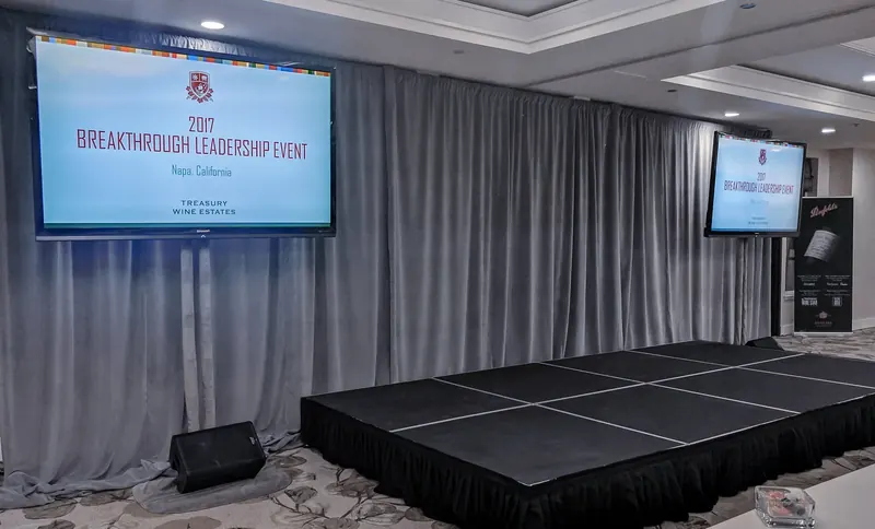 Dual monitors with silver drape and stage at the Westin